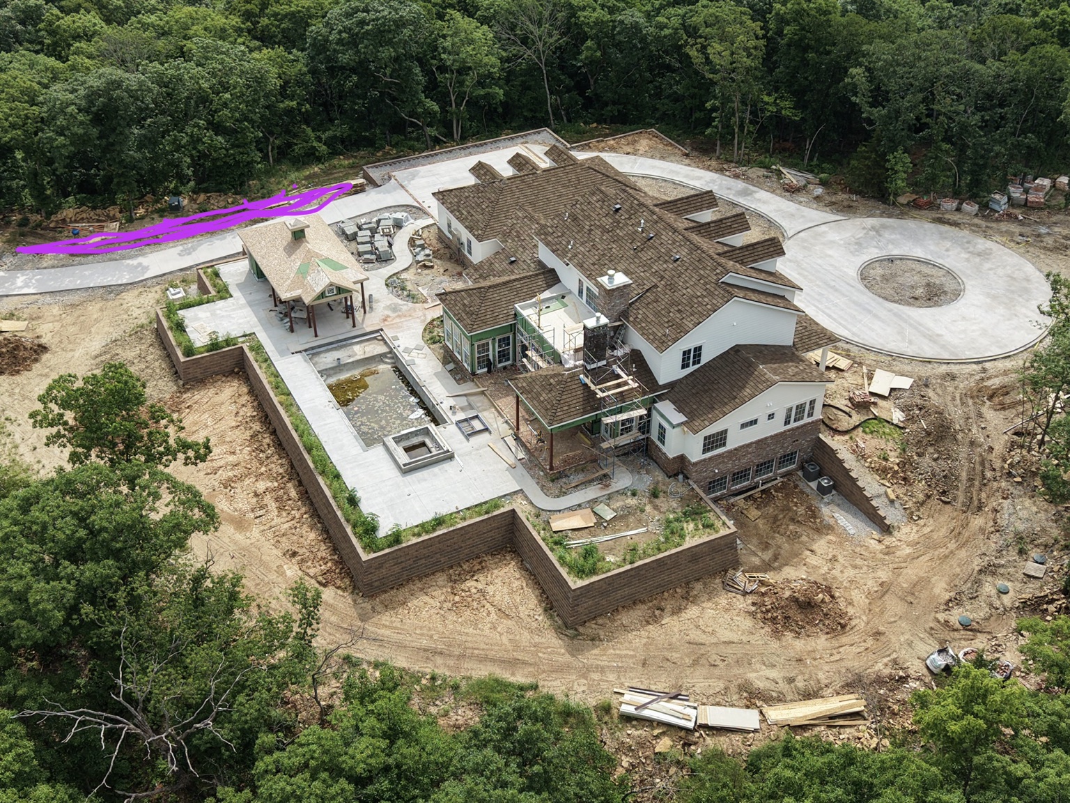 High angle aerial of a large custom home construction site